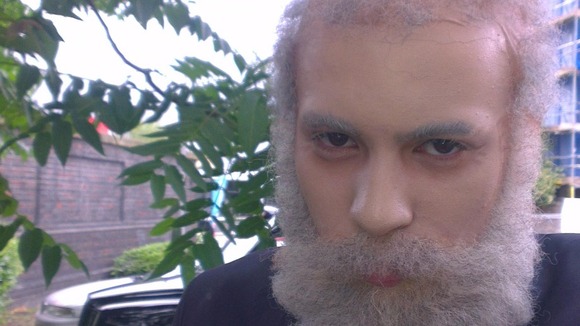 Miles Alura, 16, wearing facial prosthetics, make-up and hair pieces to disguise himself as an old man.