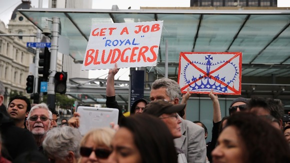 Prince Charles met by protestors.