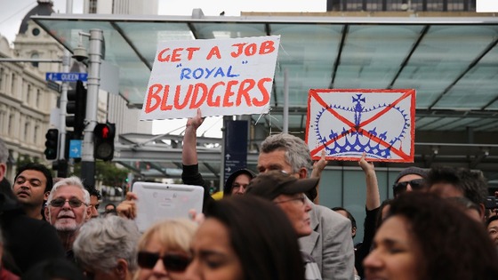 Prince Charles met by protestors.