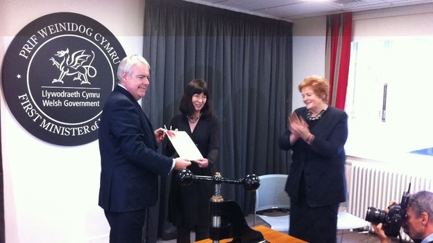 First Minister Carwyn Jones hands the sealed Welsh Act to National Assembly Clerk Claire Clancy