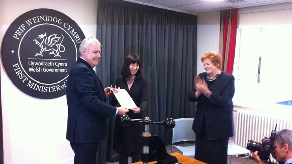 First Minister Carwyn Jones hands the sealed Welsh Act to National Assembly Clerk Claire Clancy