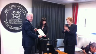 First Minister Carwyn Jones hands the sealed Welsh Act to National Assembly Clerk Claire Clancy