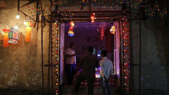 People enter a shop decorated with lights at a market in Mumbai