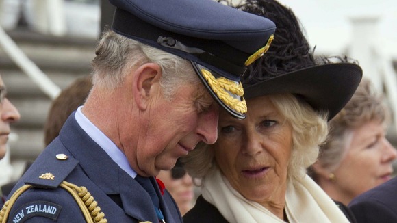 Camilla, Duchess of Cornwall, speaks to her husband Britain's Prince Charles during an event to commemorate Armistice Day in Auckland