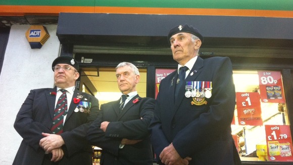 Jack Colbert from the Royal British Legion, shop owner Jeff Cheetham and standard bearer Ian Mackie outside the shop