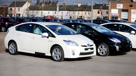 Toyota Prius hybrid cars inside a compound near a Toyota showroom in Burton on Trent
