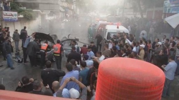 Palestinians gather at the scene of an airstrike