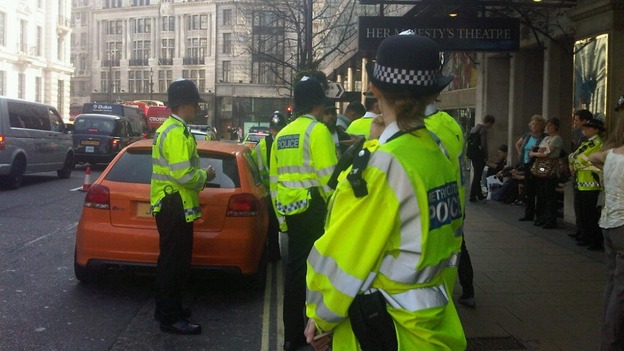 Police stop a car in the West End