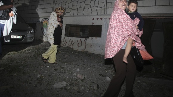 Palestinians run out of their houses following Israeli air strikes in Gaza