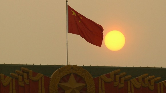 The national flag flies from the top of the National Museum of China, opposite of the Great Hall of the People