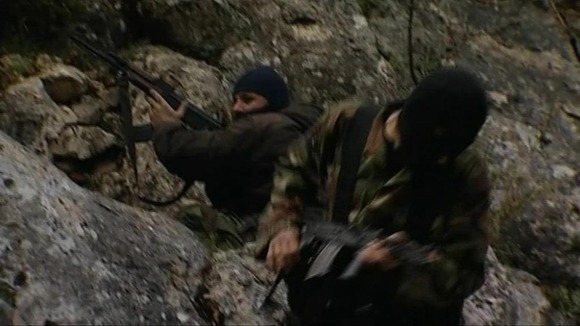 Rebel fighters who have retreated out of Homs on the border with Syria