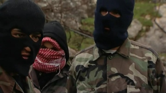 Rebel fighters who have retreated out of Homs on the border with Syria