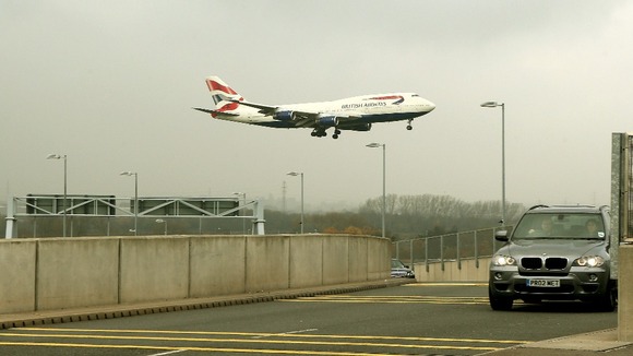 A plane lands at Heathrow Airport as overnight fog caused travel disruption across the UK.