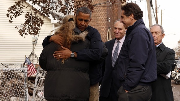 US President Barack Obama hugs resident Debbie Ingenito as he tours a hurricane battered Staten Island