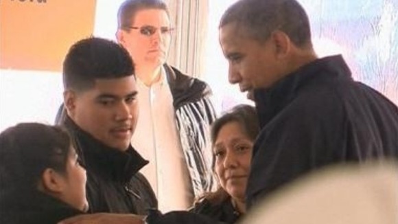 President Obama meets a family at an aid distribution tent in New York