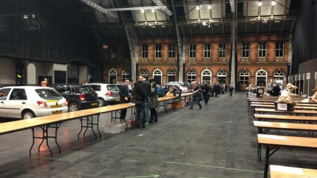 Cars drop ballot boxes off at the Manchester Central Convention Complex