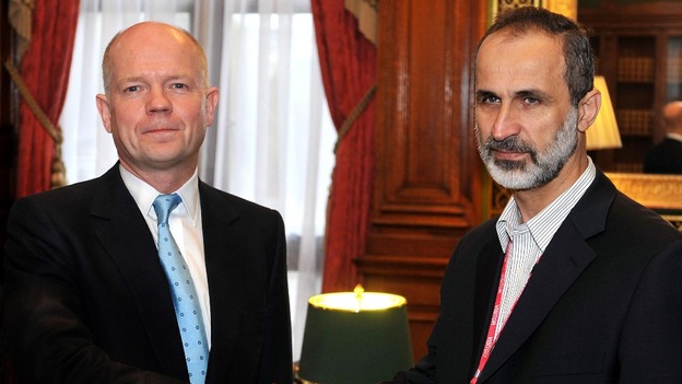 Foreign Secretary William Hague shakes hands with President Sheikh Ahmed Mu'az Al-Khatb of the Syrian opposition movement.