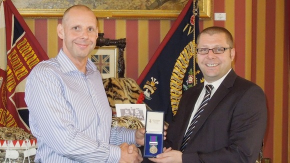 Stan Bates (left) reuniting Mick France with his missing medal.