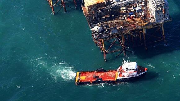 Rescue crew surrounds an oil platform