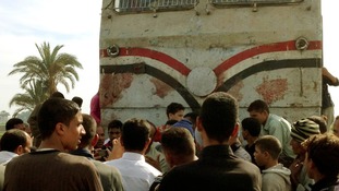 Relatives of victims look at the wreckage in Manfalut.