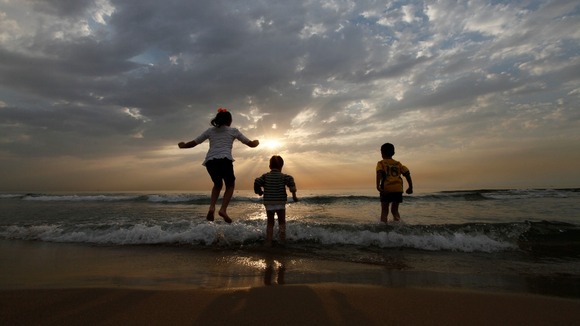 Syrian children from Aleppo jump into the Mediterranean sea
