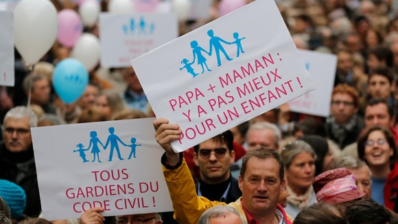 Protestors hold placards and balloons during a demonstration against a draft law to allow same-sex marriage in Pari