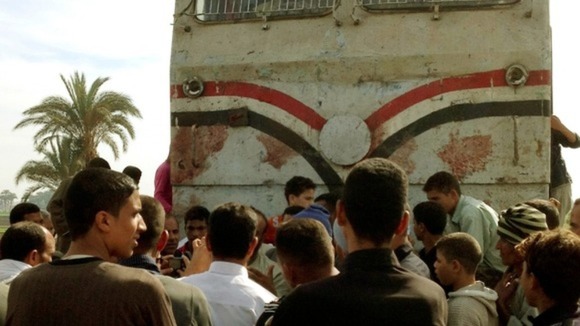 Relatives of victims look at the wreckage in Manfalut