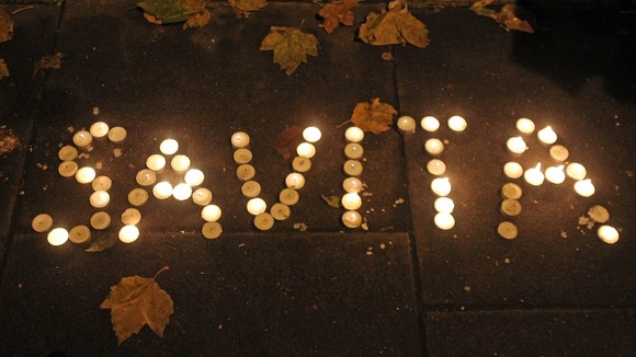 Candles are left in tribute outside Leinster House in Dublin