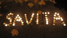 Candles are left in tribute outside Leinster House in Dublin