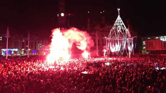 A flare marks the end of the performance by a group of French trapeze masters