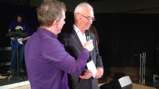 Pastor David Hinds welcoming Mike Howitt back from his hitchhike to South Africa