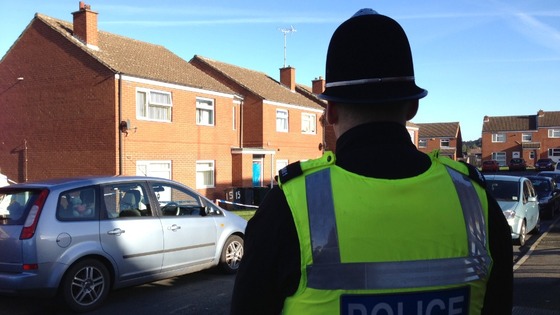 Police officer stands guard in Denaby