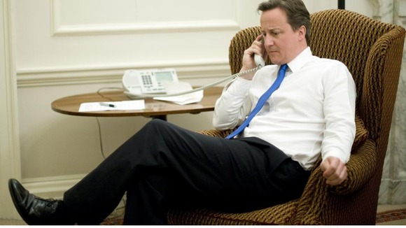 A library photo of David Cameron on the phone