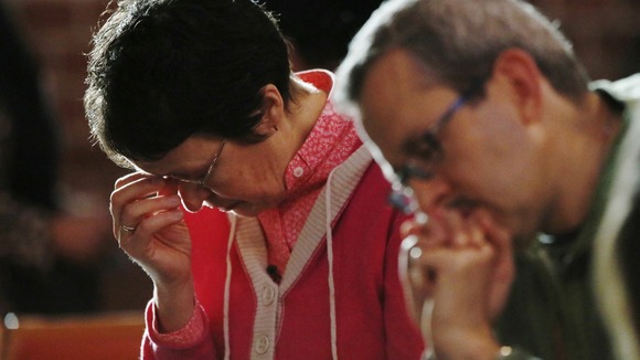 The Reverend Jane Morris prays at St Gabriels Church in Cricklewood, north London