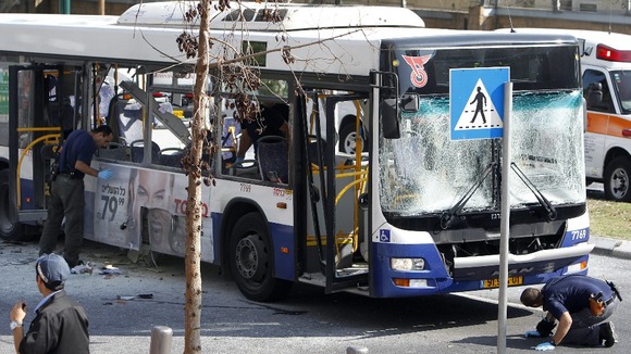 Israeli police survey the scene after an explosion on a bus in Tel Aviv