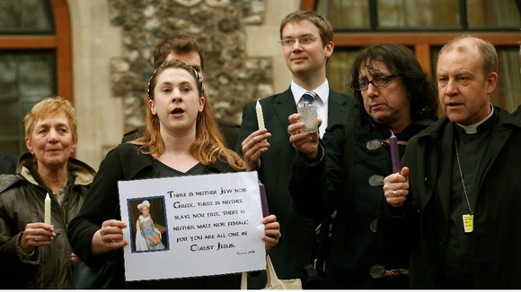 Demonstrators sing during a vigil calling for equality in the church, outside the General Synod of the Church of England
