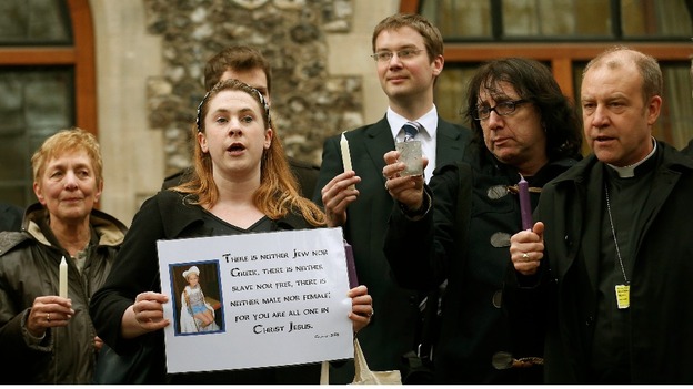 Demonstrators sing during a vigil calling for equality in the church, outside the General Synod of the Church of England