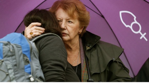 Two women hug during the vigil outside the Church of England's Church House
