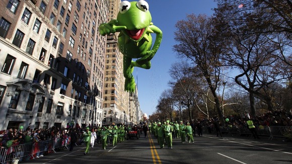 Kermit the Frog balloon floats down Central Park West during the Thanksgiving Day Parade