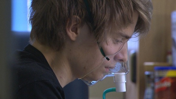 Boy in hospital attached to repirator