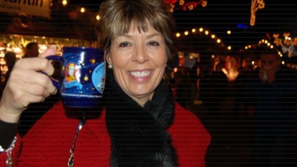 Woman smiling holding up mug