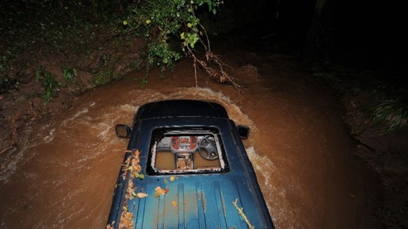 The car was trapped under a bridge.