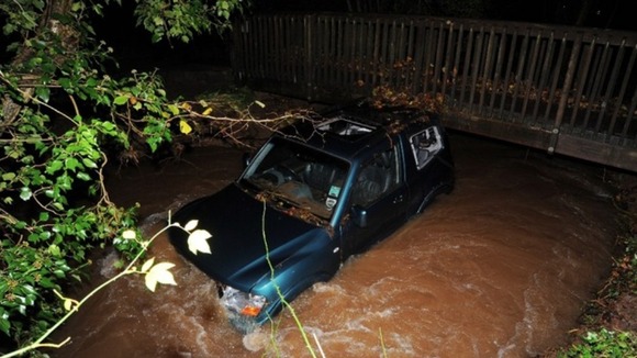 Car stuck under bridge
