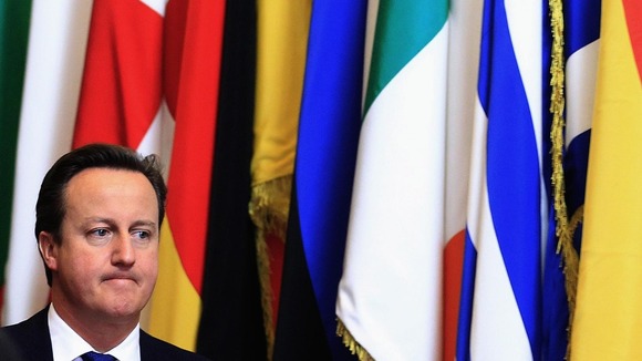 David Cameron, in front on some EU flags
