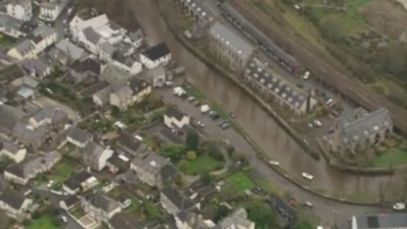 Flooding blocks roads and floods houses in Exeter.