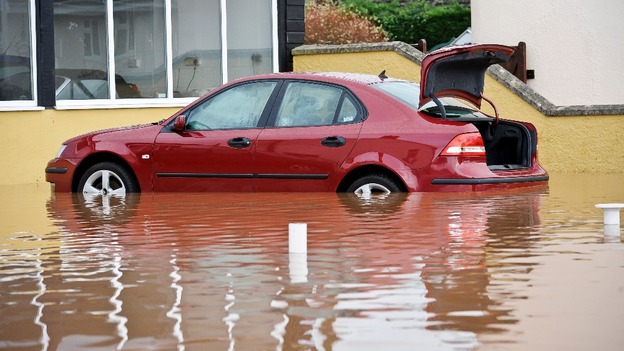 A car is partially submerged in standing water in Somerset.