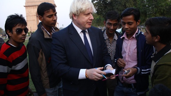 London Mayor Boris Johnson signing autographs near India Gate.