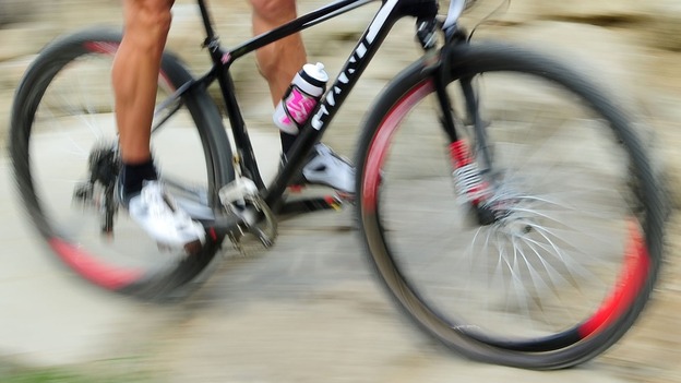 A woman riding a bike very fast
