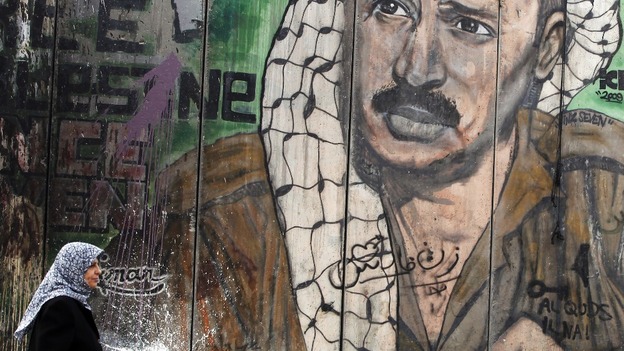 Palestinian leader Yasser Arafat is depicted on a barrier in Israel