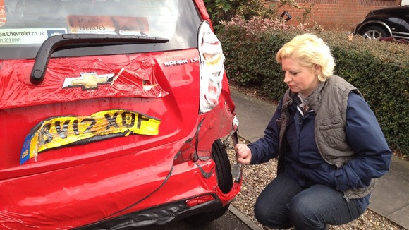 Resident asses damage to car 